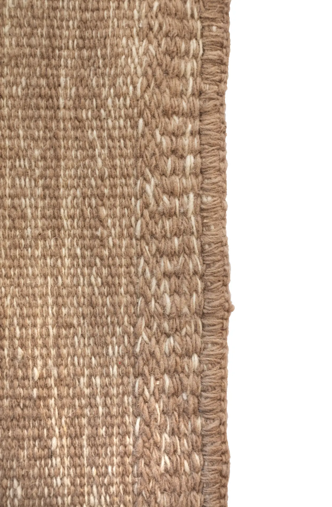 Close-up of the twining border and embroidered closing row on a Mono rug, showing the textured edge in tan and white wool. By Thurje Handmade, Korça, Albania.