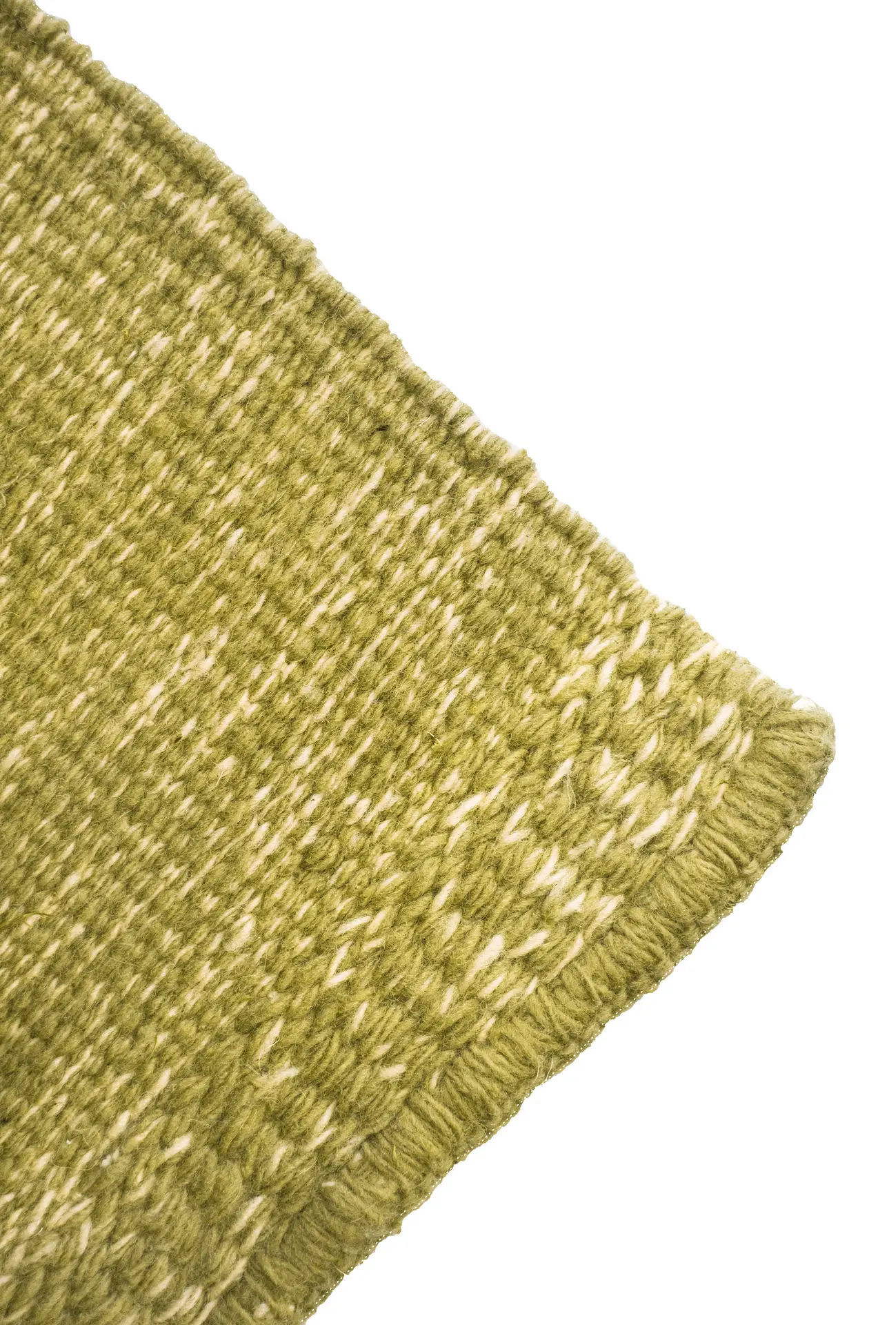 Corner detail of a Mono rug, showing the twining border and double-scale surface texture in grass green mixed with white wool. By Thurje Handmade, Korça, Albania.